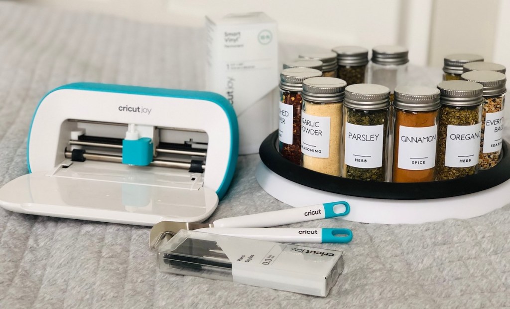 cricut machine sitting on blankets with labeled spice jars