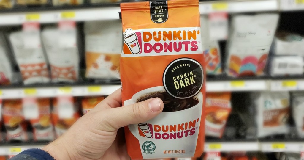 hand holding bag of dunkin coffee