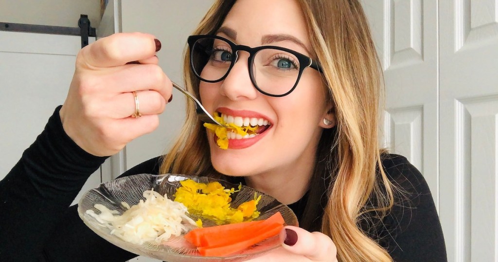 woman eating from plate with white yellow and orange fermented food
