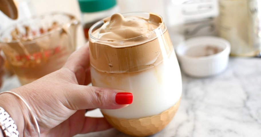 holding a whipped instant coffee drink