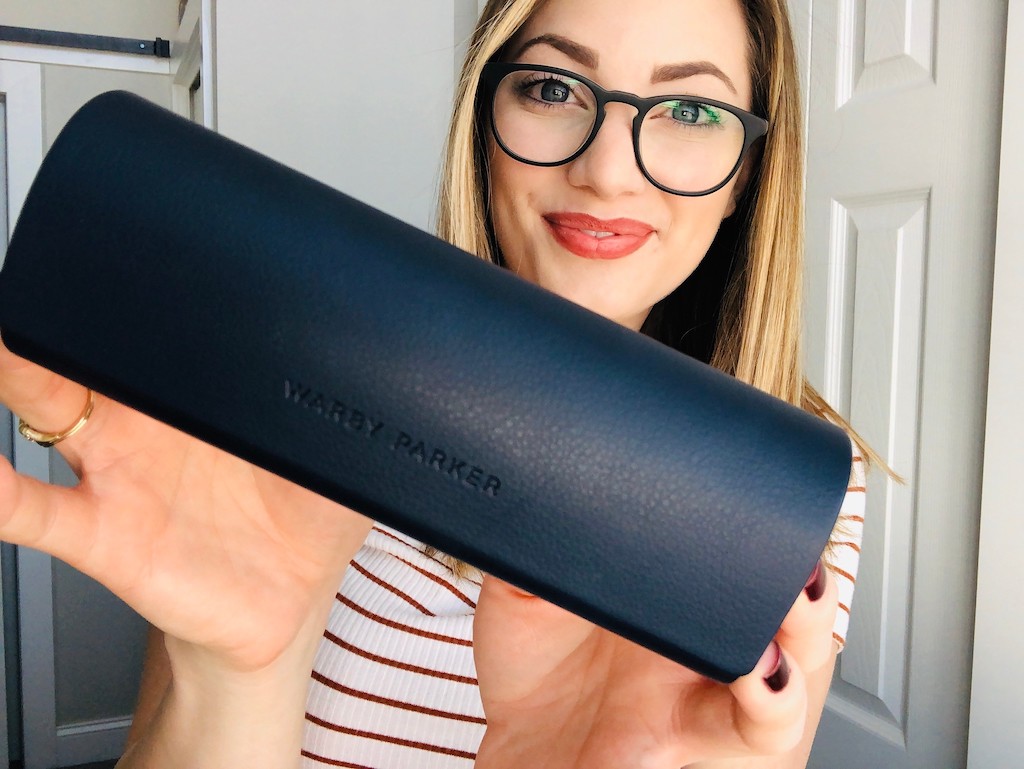 woman holding Warby Parker glasses case 