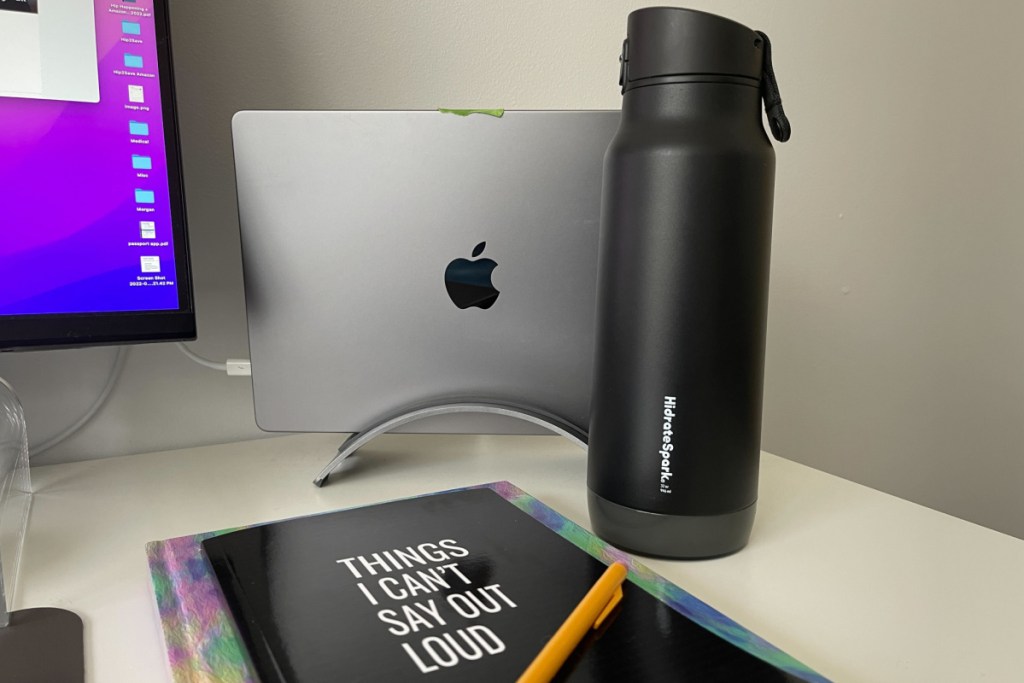 laptop and water bottle on desk