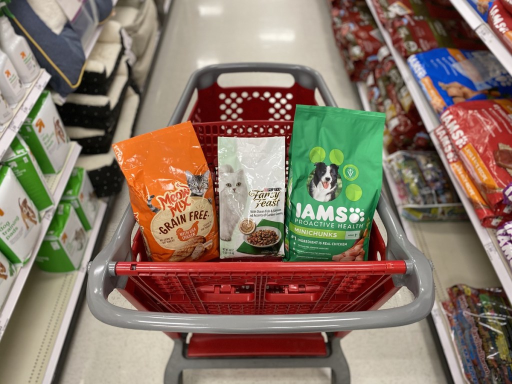 target shopping cart with bags of dog and cat food in front basket