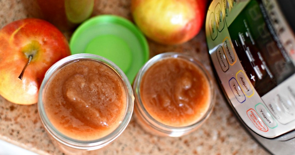pot with applesauce in jars next to it