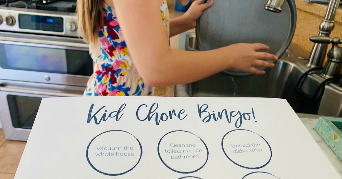 kids chore bingo printable with girl in background washing dishes 