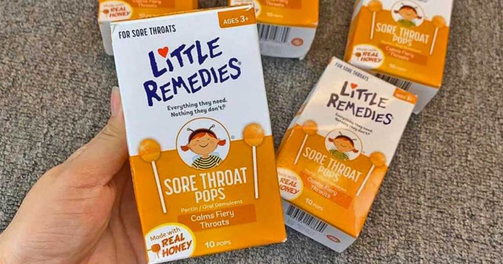 hand holding Little Remedies Sore Throat Pops w/ Honey 10-Count Pack