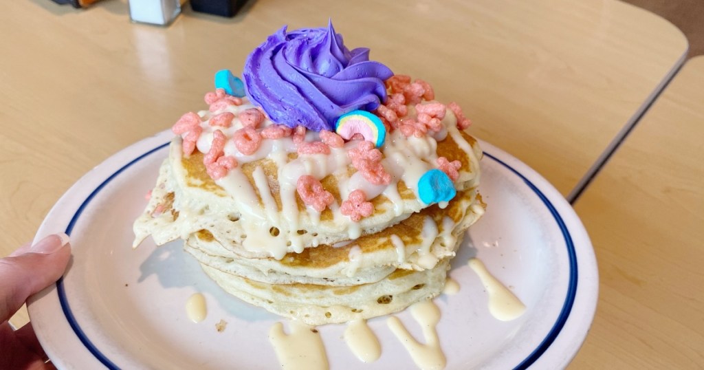 pancakes topped with cereal and purple icing