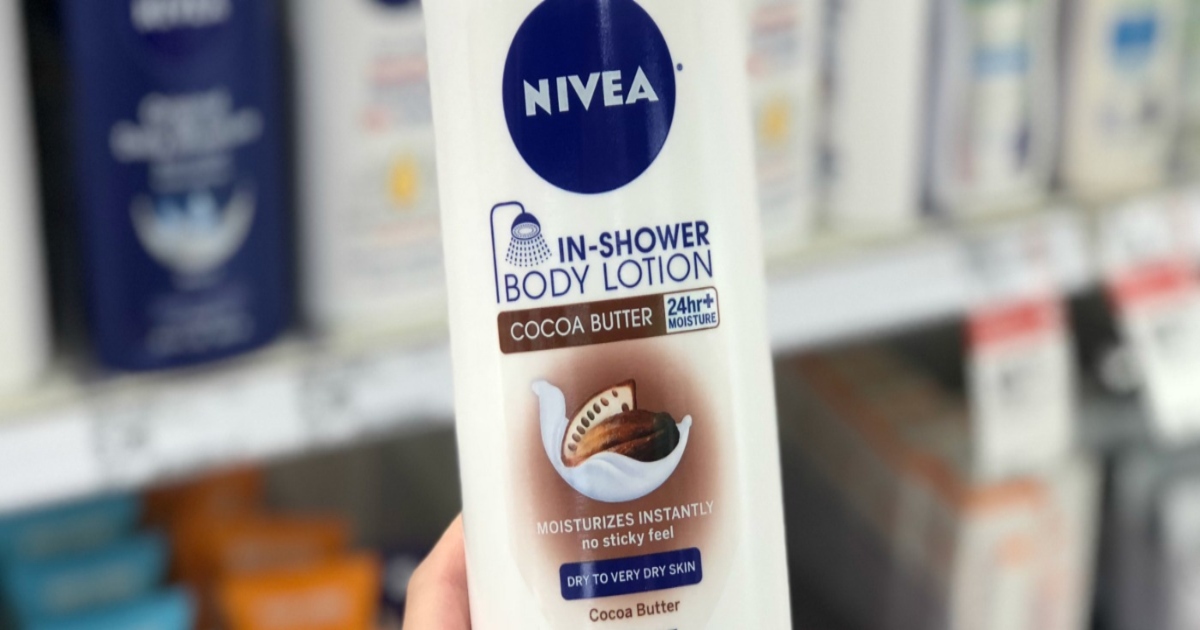 Nivea In show body lotion, held by a hand in store, in front of a row of other nivea items