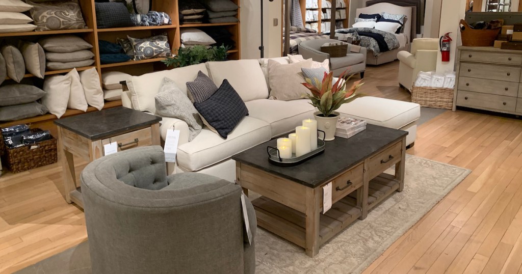 store living room set up with couch pillows coffee table and chair