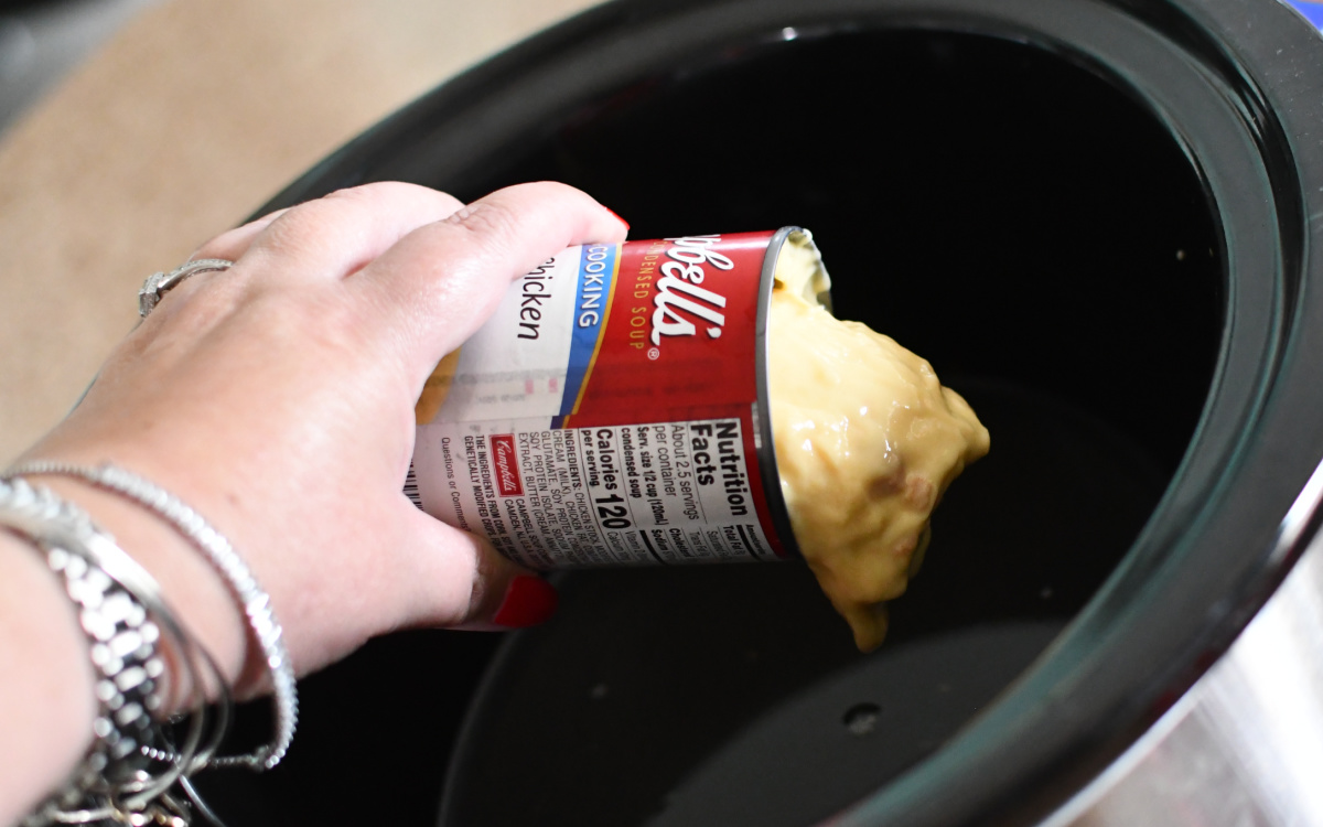 pouring Campbell's cream of chicken soup can in crock pot