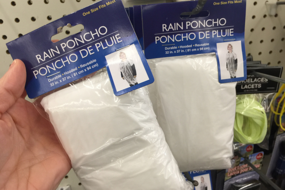 hand holding rain ponchos in in bags