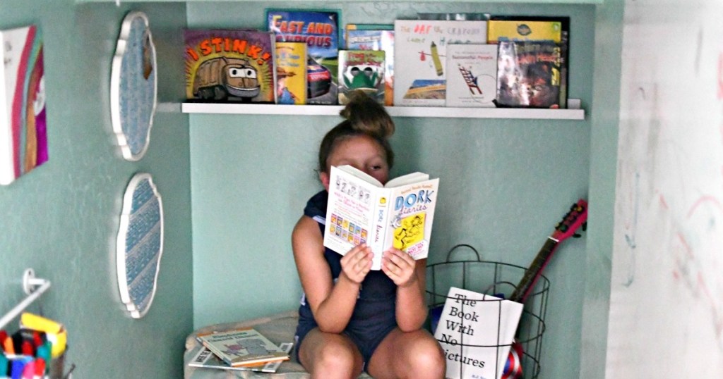 girl reading a book summer reading program