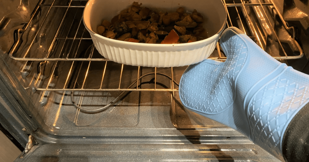 grabbing dish out of oven with silicone oven mitt