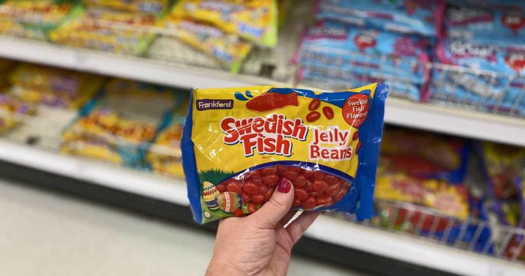 hand holding a bag of Swedish Fish Jelly Beans
