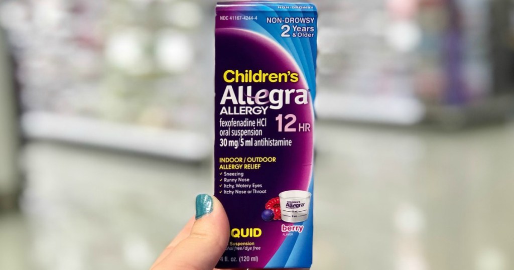 hand holding children's allergy medication in a store