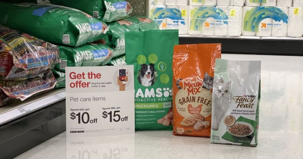 bags of pet food on floor at store next to sale sign
