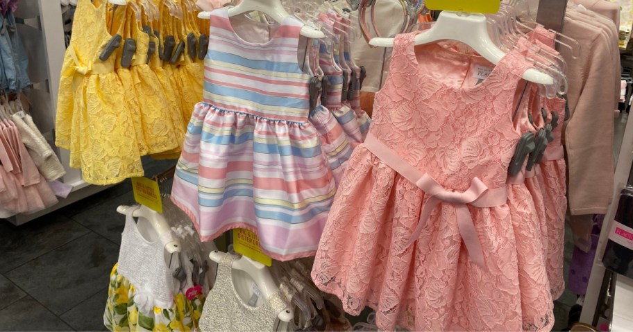 girls dresses on store wall display
