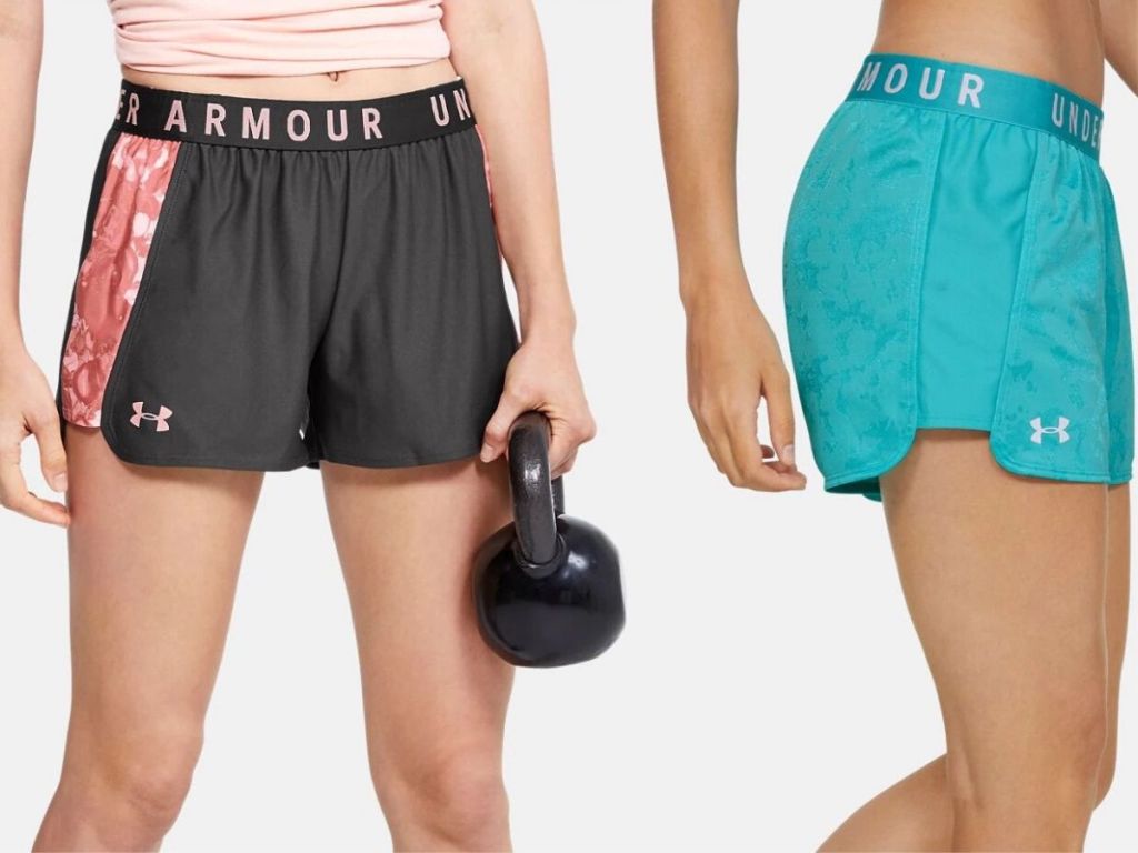 two women's lower body wearing athletic shorts, one on left holding a kettlebell