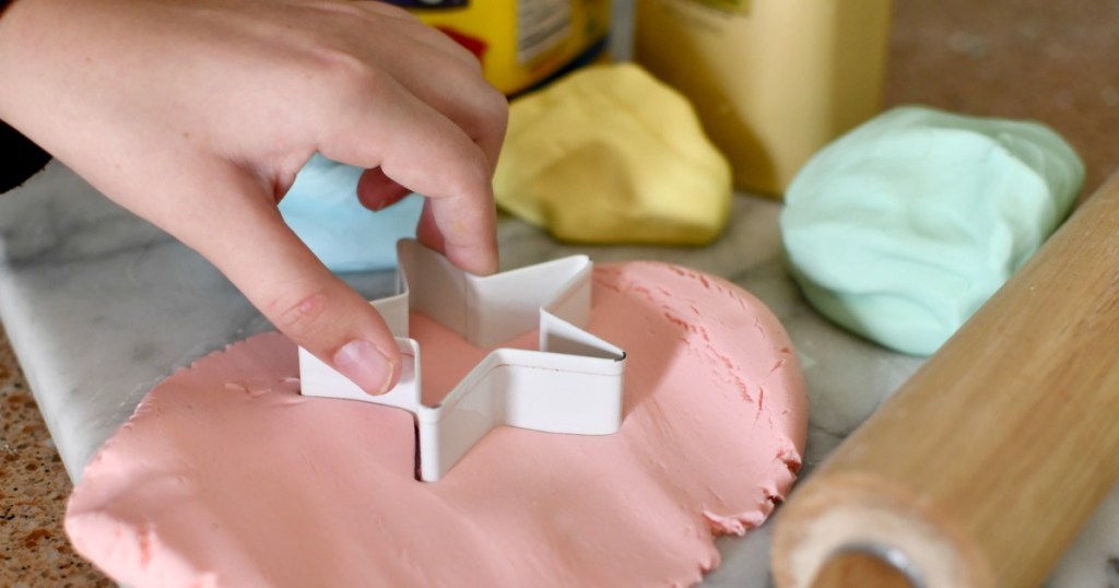 using a cookie cutter with homemade play-dough
