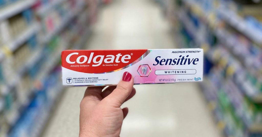hand holding toothpaste in a store