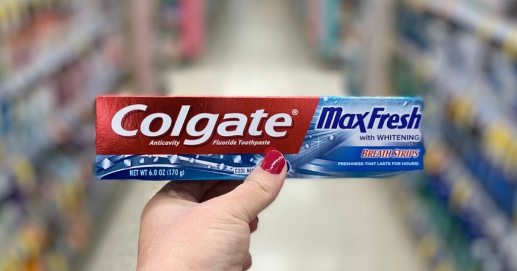 hand holding toothpaste in a store