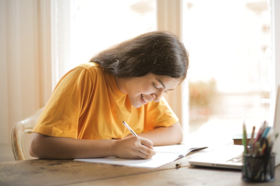 teenager doing homework by filling out printable children's activities