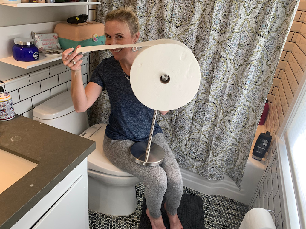 woman holding large Charmin Forever roll