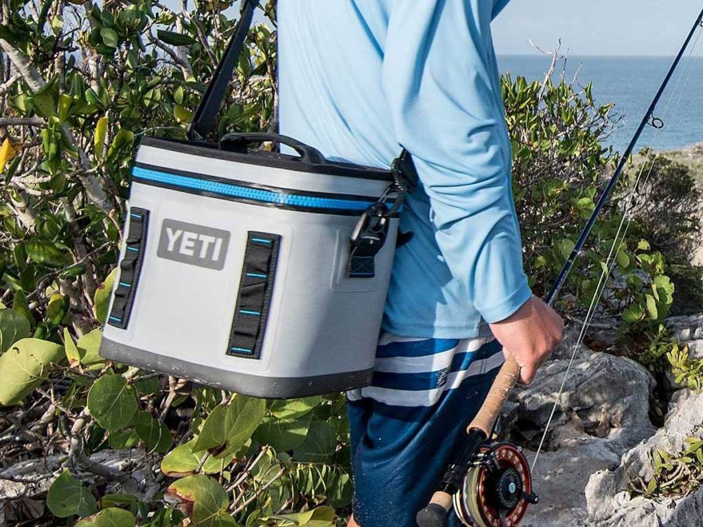carrying a Yeti cooler by the shoulder strap