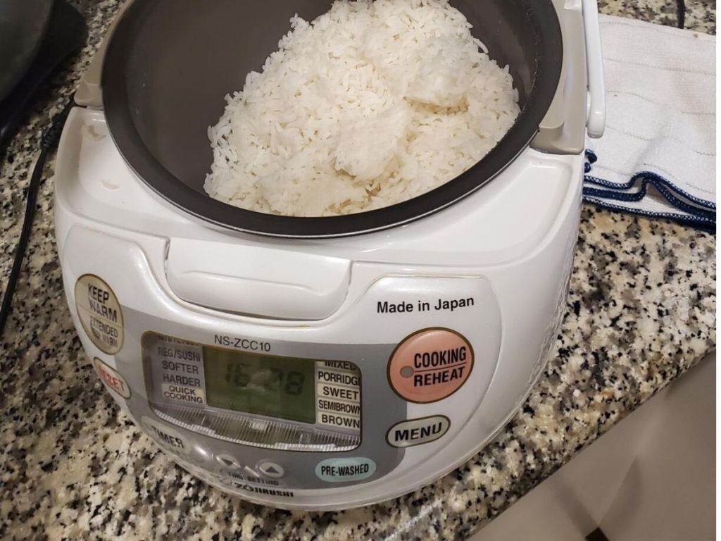 zojirushi rice cooker open on counter filled with cooked white rice