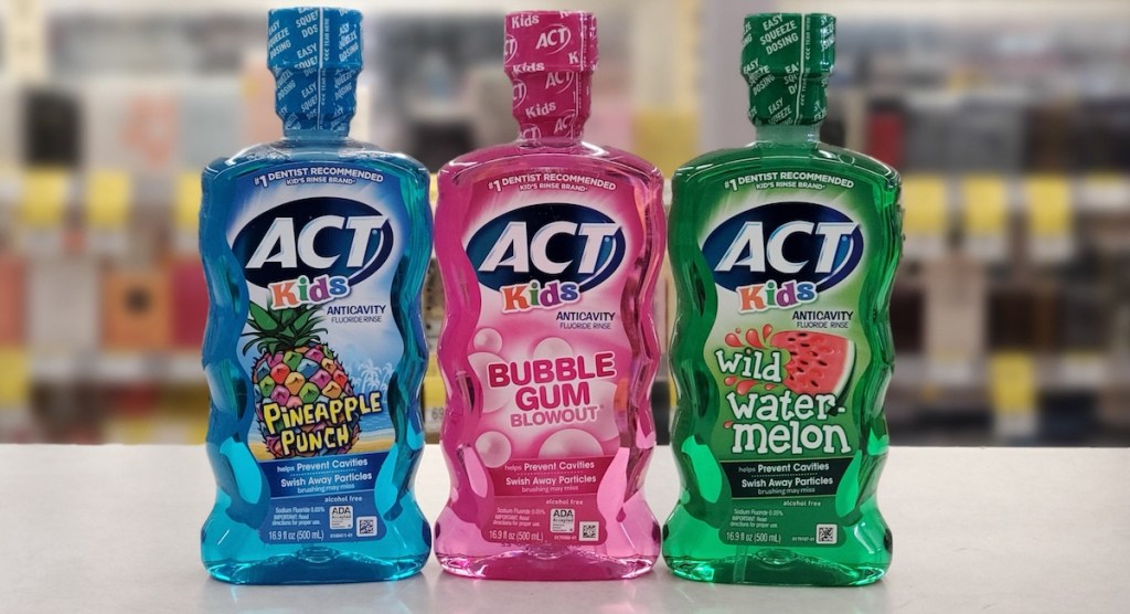 three bottles of ACT mouthwash on counter