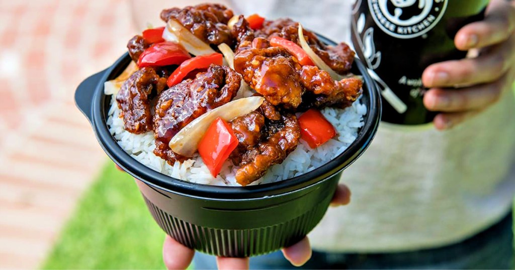 Beijing Beef Bowl at Panda Express in persons hand with drink in other hand