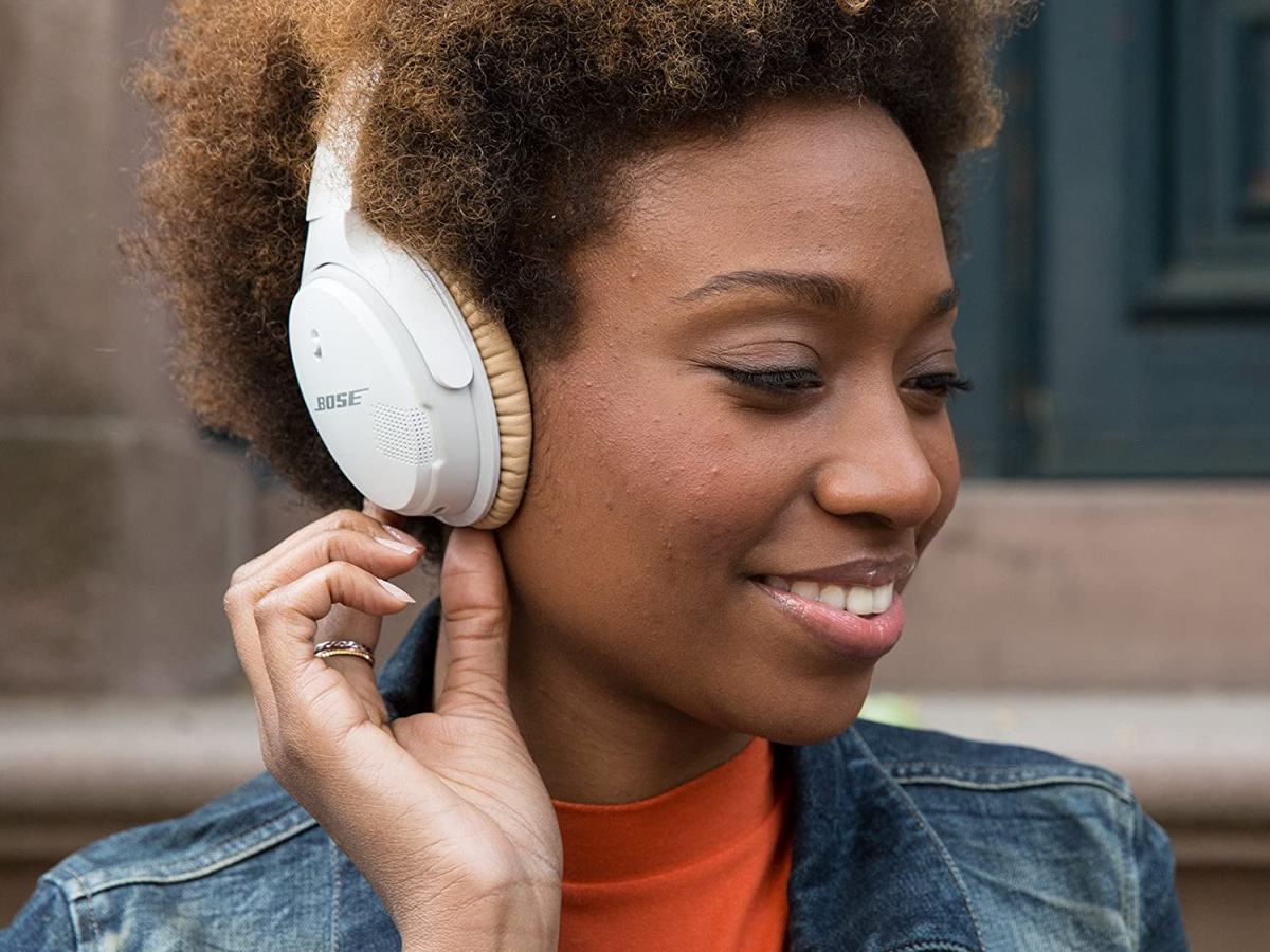 woman wearing white and tan bose headphones