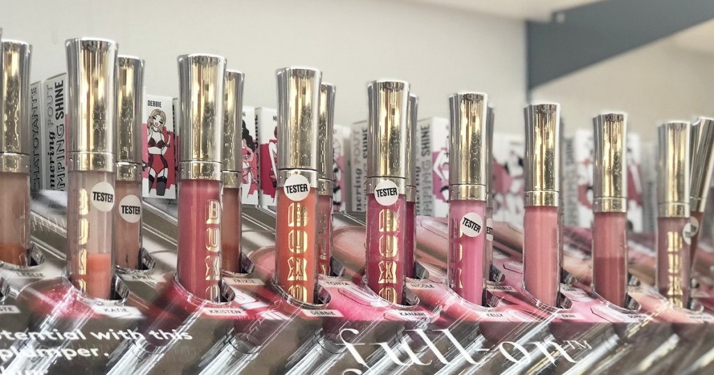 multiple tubes of buxom lip gloss in a store display