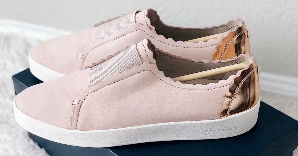light pink slip on sneakers with metallic gold on back heels