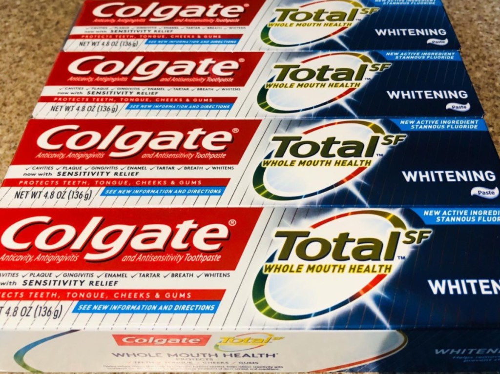 four boxes of toothpaste on counter