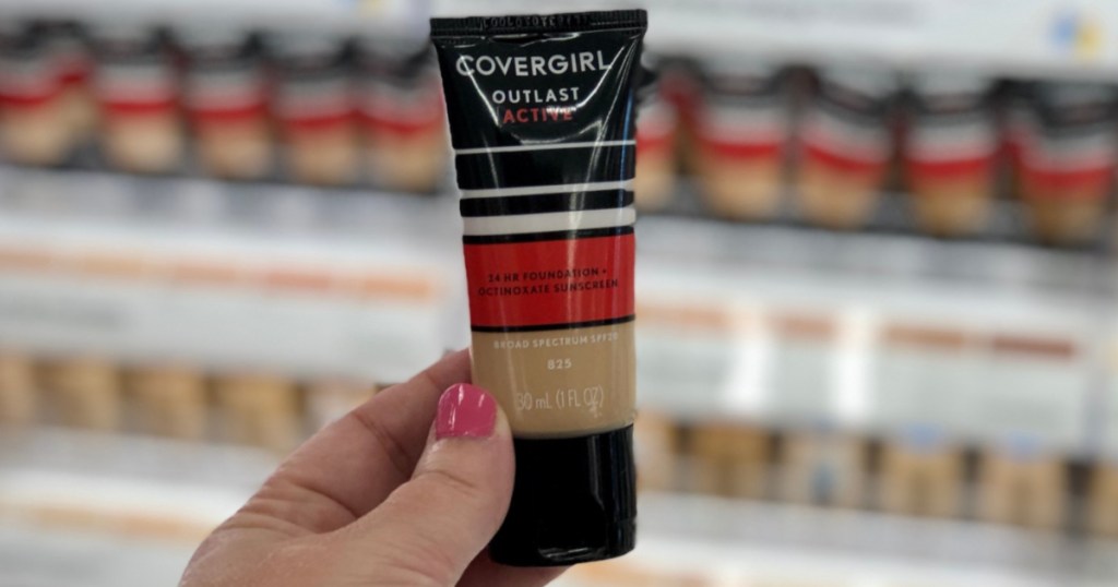 hand holding covergirl foundation