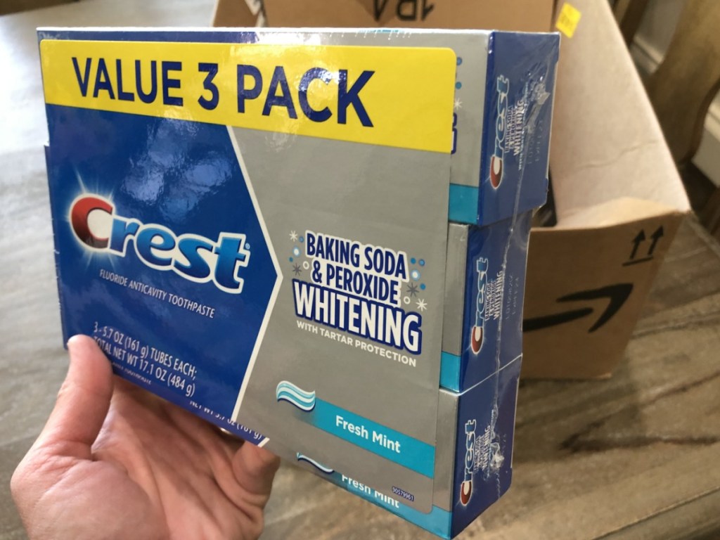 Person holding Crest Fresh Mint Value Pack Toothpaste