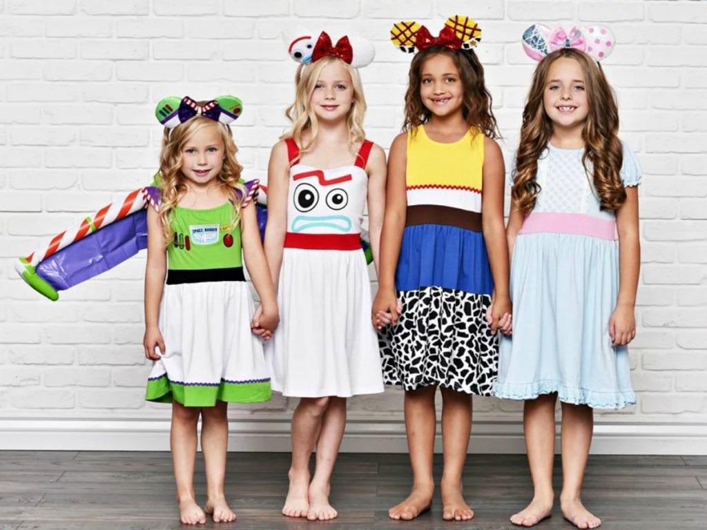 Four girls wearing a variety of Disney themed character dresses