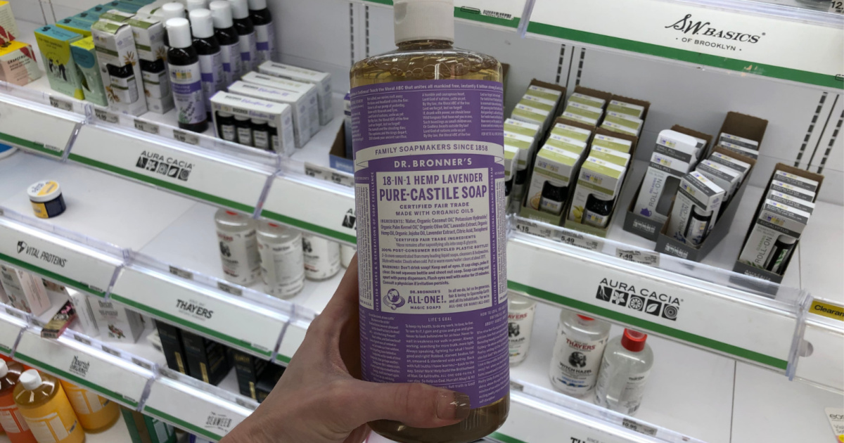 hand holding purple bottle of castile soap in store aisle