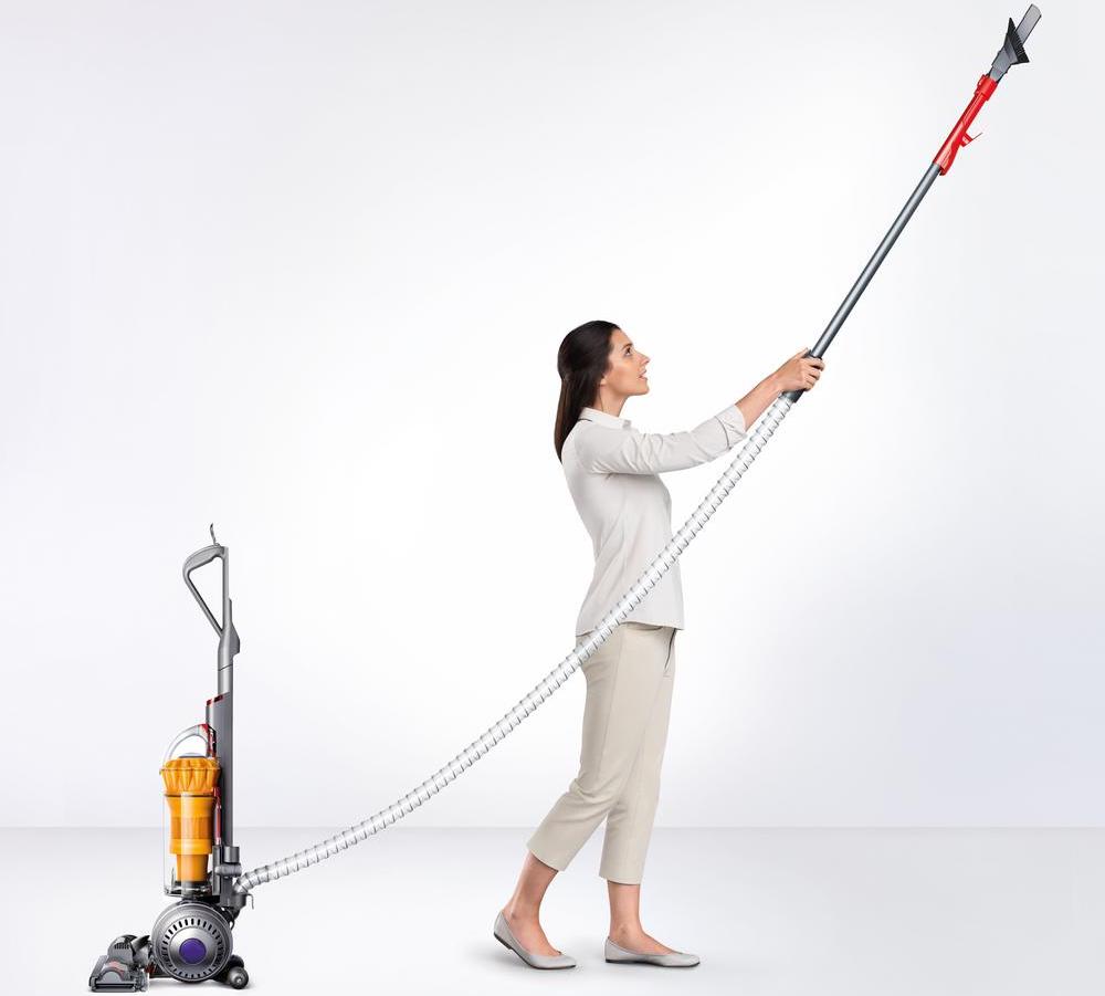 woman vacuuming the ceiling