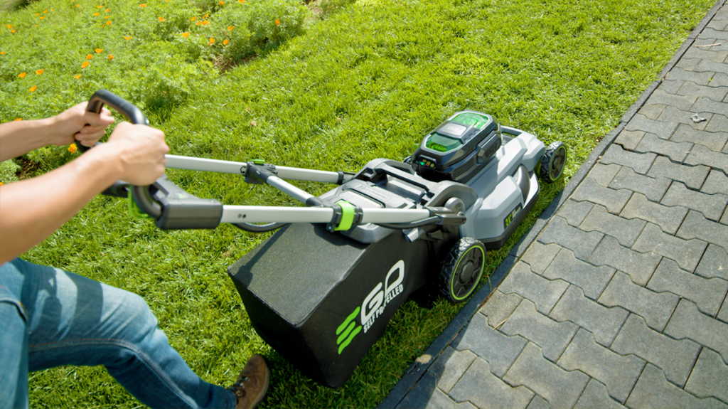 person pushing a lawn mower