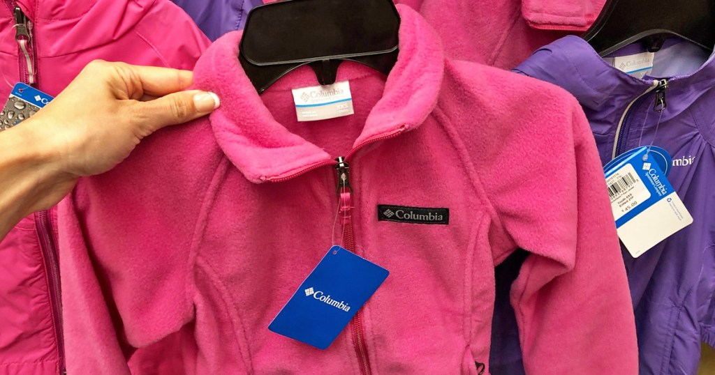 hand holding up bright pink fleece columbia brand jacket
