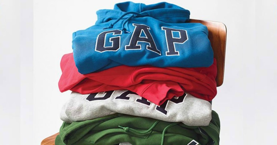 pile of GAP sweatshirts on a chair