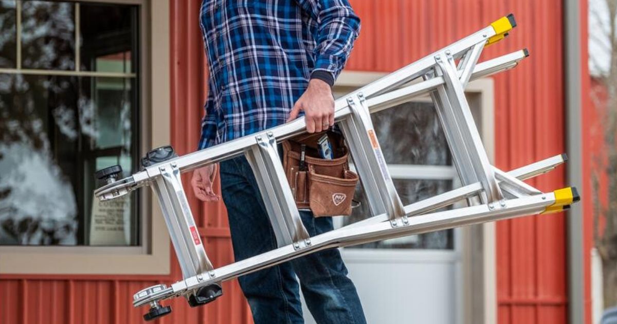Man carrying 18 foot metal ladder