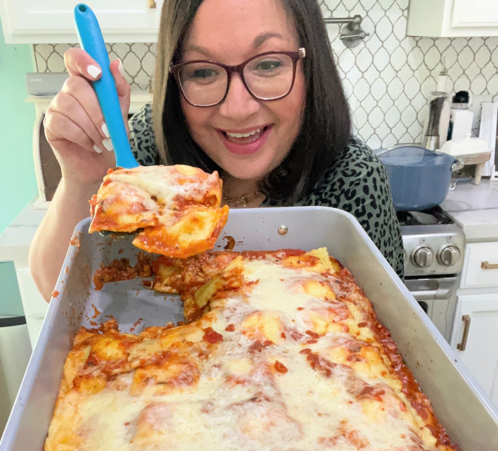woman holding a ravioli baked dinner 