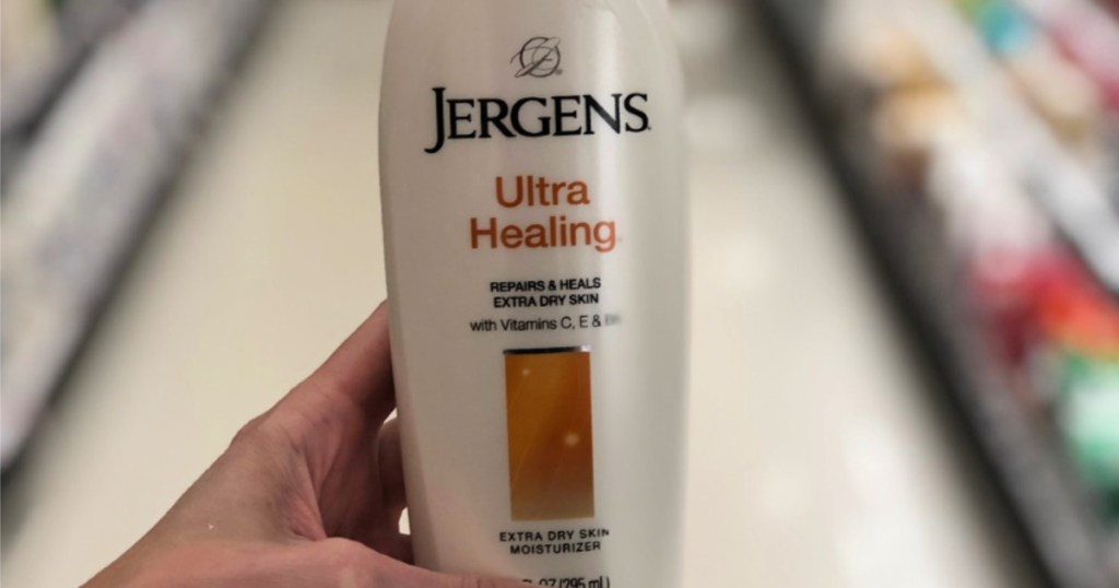 hand holding bottle of jergens ultra healing lotion