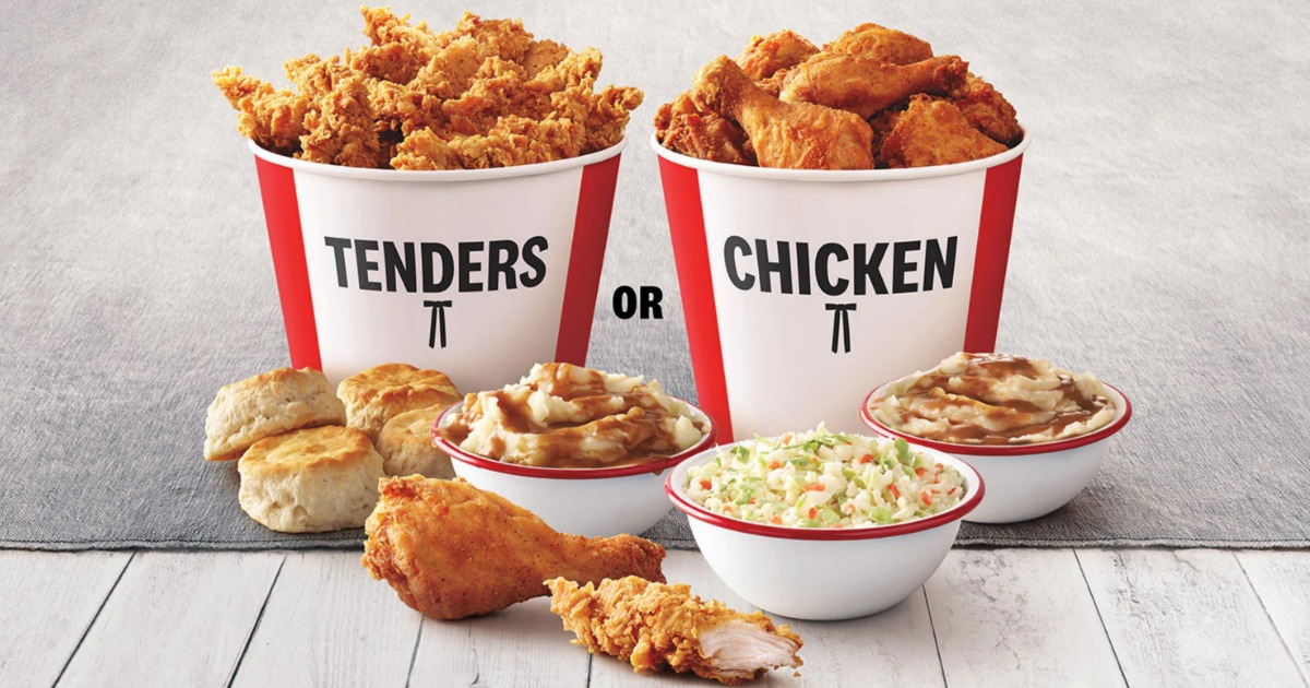 KFC Buckets filled with chicken next to mashed potatoes and coleslaw on table