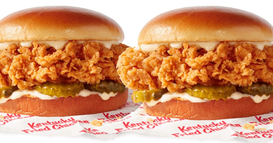 two KFC chicken sandwiches on paper