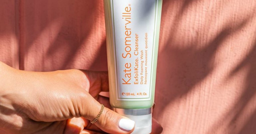 woman holding Kate Somerville Exfolikate cleanser