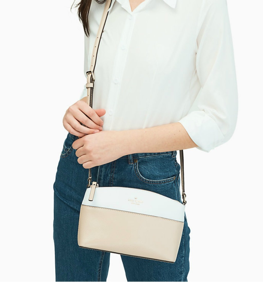 woman holding small beige and white purse